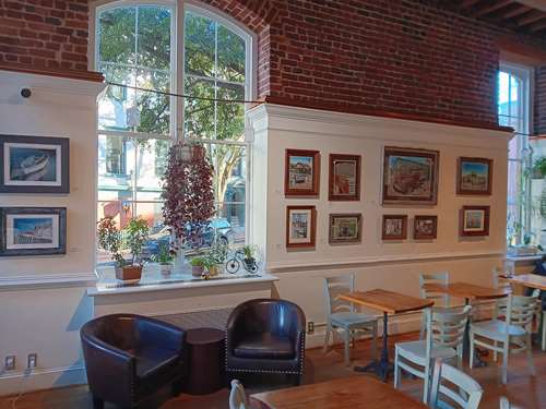 Art wall with multiple paintings by Al Bryan.